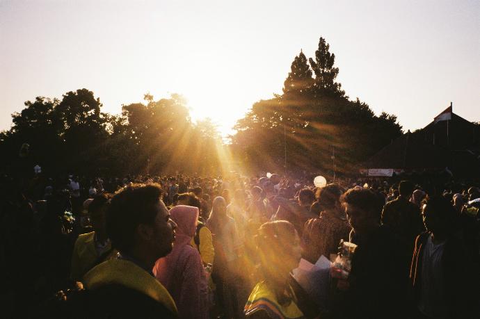 a crowd of people standing around each other